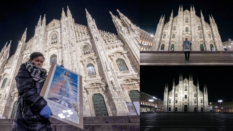 Coronavirus, donna in preghiera davanti al Duomo di Milano